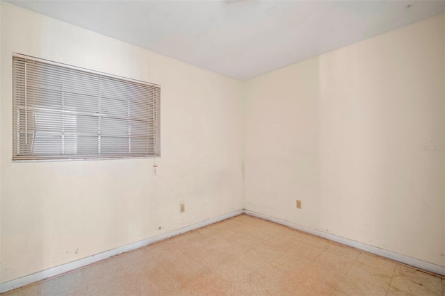 empty room with light floors and baseboards