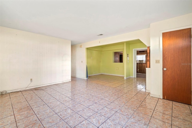 spare room with visible vents, baseboards, and light tile patterned floors