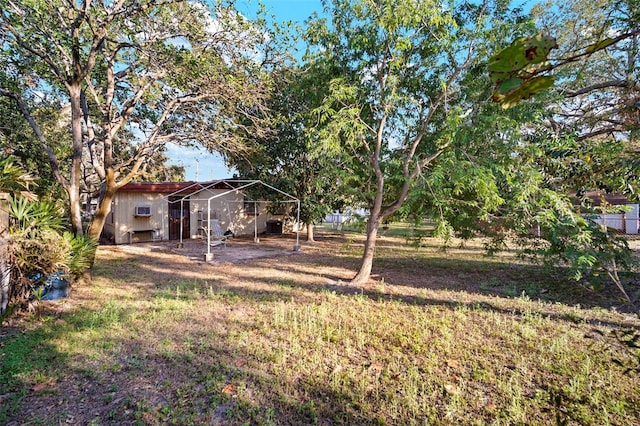 view of yard featuring fence and an outdoor structure