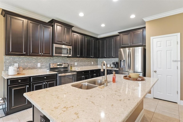 kitchen featuring light tile patterned floors, appliances with stainless steel finishes, decorative backsplash, and a sink