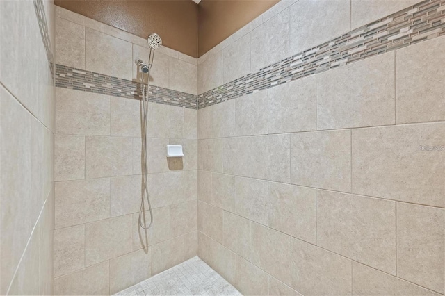 full bathroom featuring tiled shower