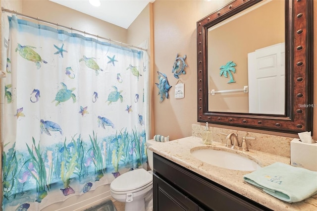 full bath with vanity, toilet, and shower / bath combo with shower curtain