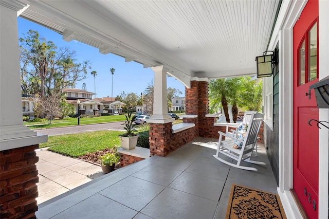 view of patio / terrace featuring a residential view and a porch