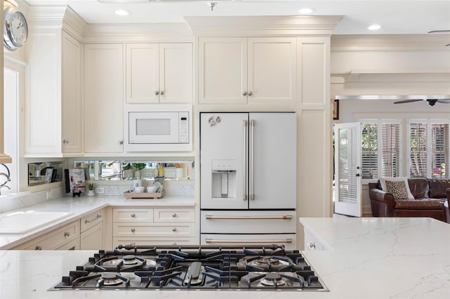 kitchen with white appliances, light stone counters, a ceiling fan, recessed lighting, and white cabinetry