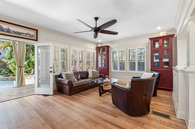 living area featuring visible vents, a ceiling fan, recessed lighting, crown molding, and light wood finished floors