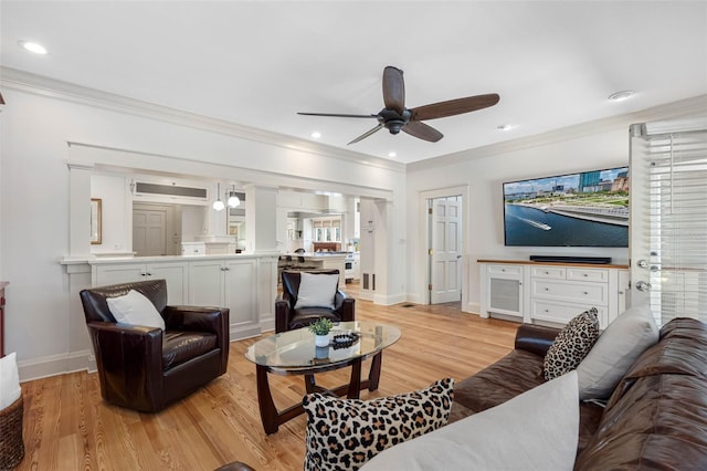 living room featuring crown molding, recessed lighting, and light wood-type flooring