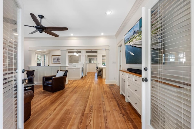 foyer with crown molding, light wood-style flooring, recessed lighting, and a ceiling fan