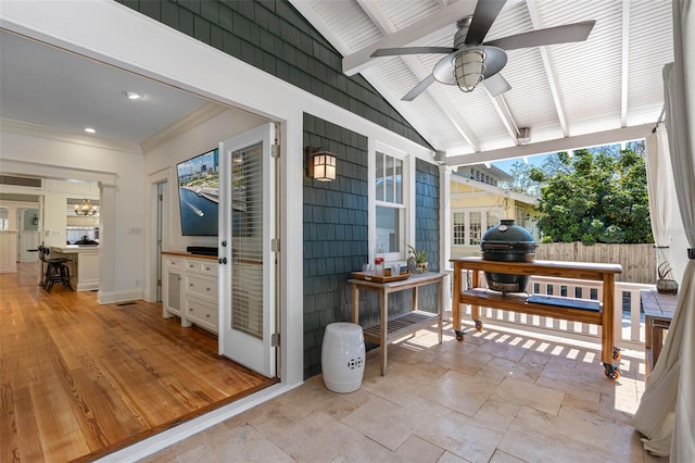 view of patio featuring ceiling fan and fence