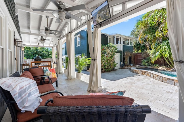 view of patio with grilling area, a fenced backyard, and a ceiling fan