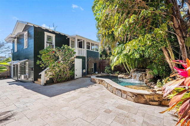 rear view of house featuring fence and a patio area