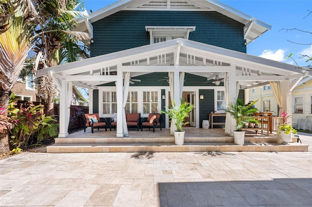 view of patio with an outdoor living space, a ceiling fan, and covered porch