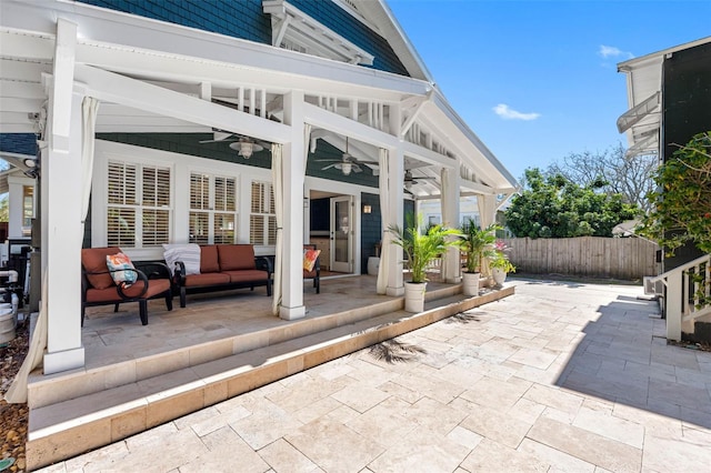 view of patio / terrace with outdoor lounge area, a ceiling fan, and fence