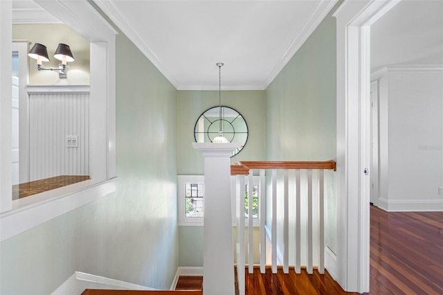 staircase with crown molding, baseboards, and wood finished floors