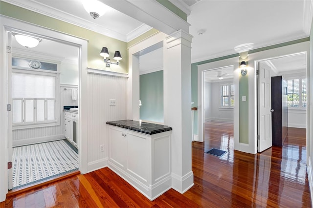 bathroom featuring a wealth of natural light, wood finished floors, crown molding, and decorative columns