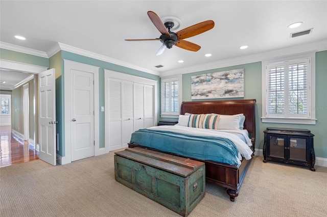 carpeted bedroom featuring visible vents, recessed lighting, baseboards, and ornamental molding