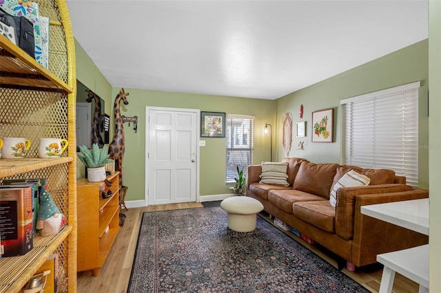 living room featuring light wood-type flooring and baseboards