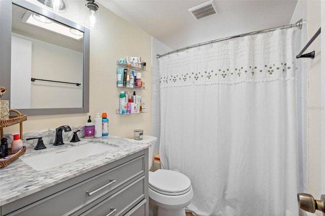 bathroom with visible vents, toilet, and vanity