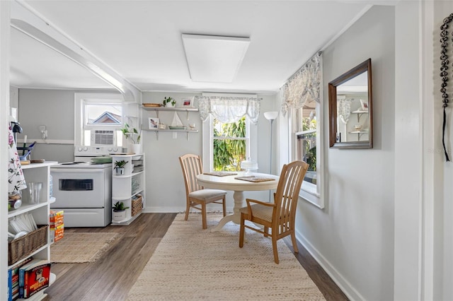 dining area with baseboards and wood finished floors