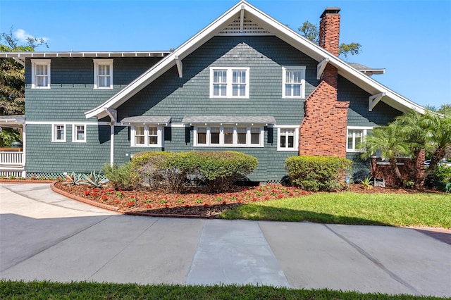 exterior space with a front yard and a chimney