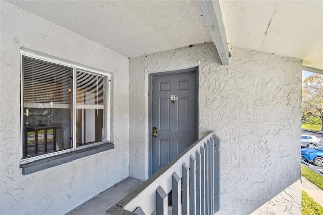 doorway to property with stucco siding