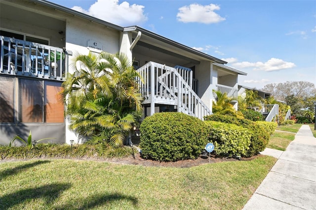 view of property exterior featuring a lawn and stucco siding