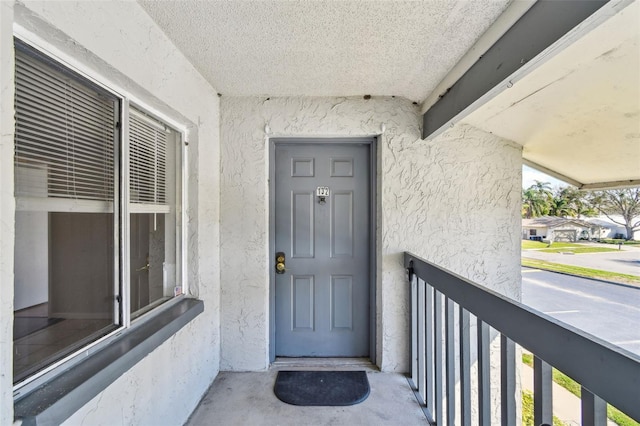 doorway to property with stucco siding