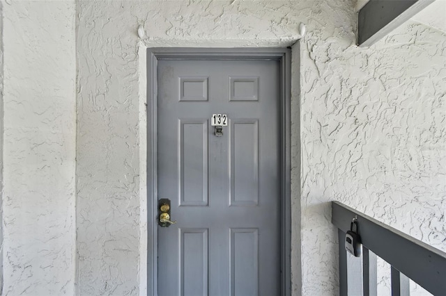 view of exterior entry with stucco siding