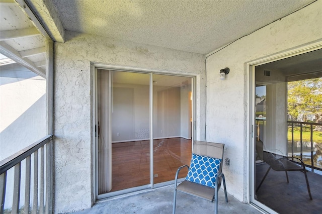 doorway to property featuring stucco siding