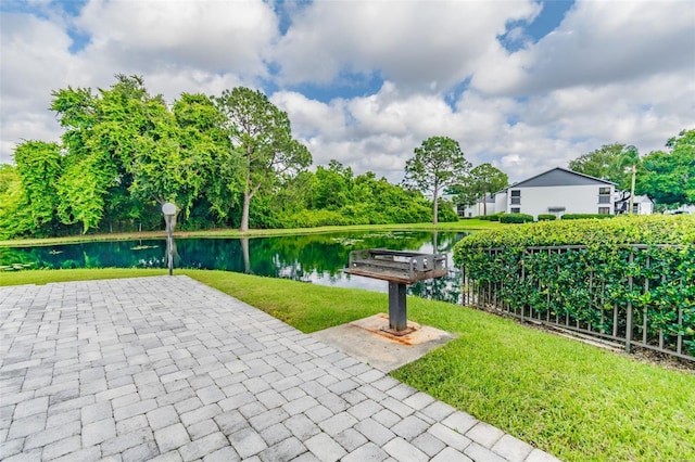 view of community featuring a water view and a yard