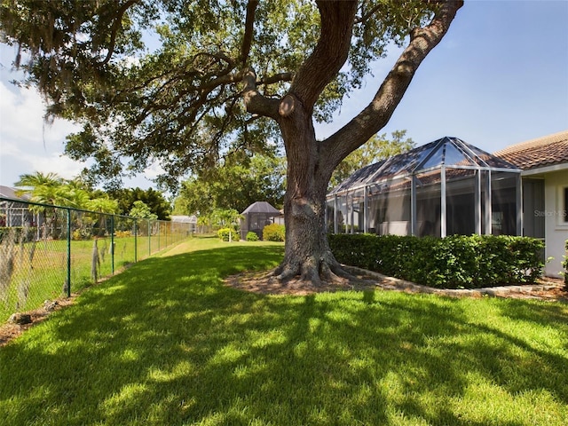 view of yard featuring a lanai and a fenced backyard