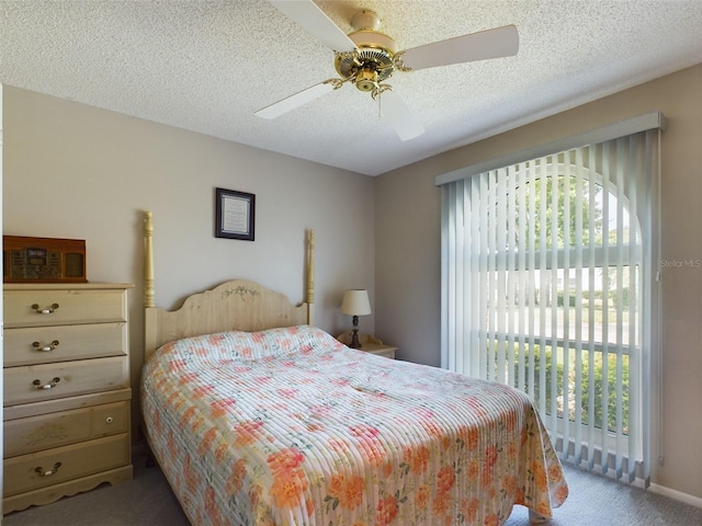 bedroom featuring a textured ceiling, multiple windows, carpet, and a ceiling fan