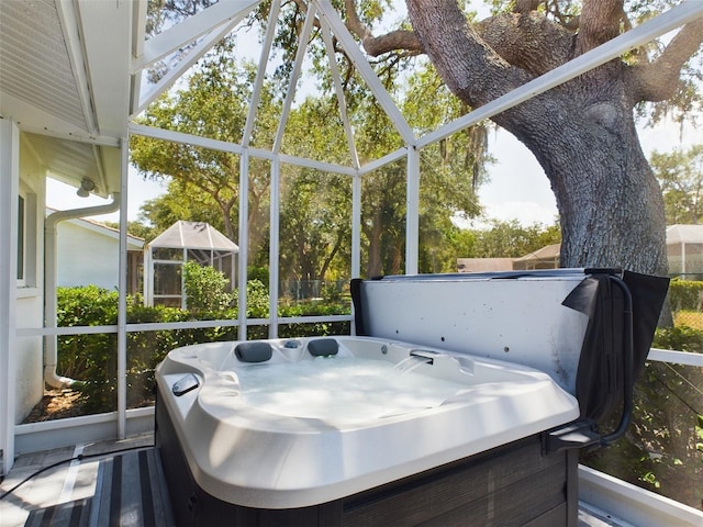 sunroom / solarium with a wealth of natural light and a jacuzzi