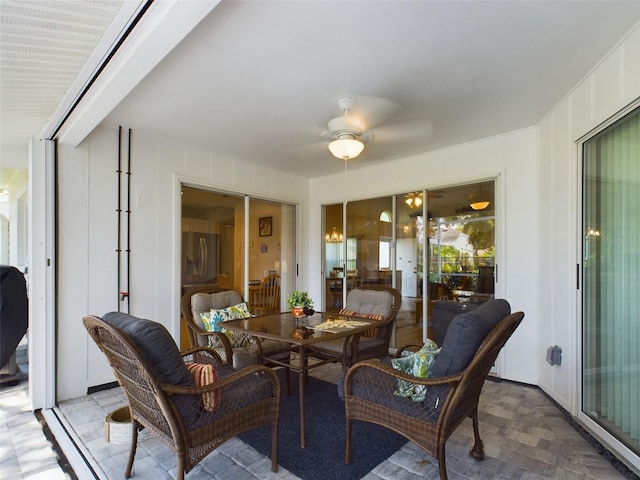 sunroom with a ceiling fan