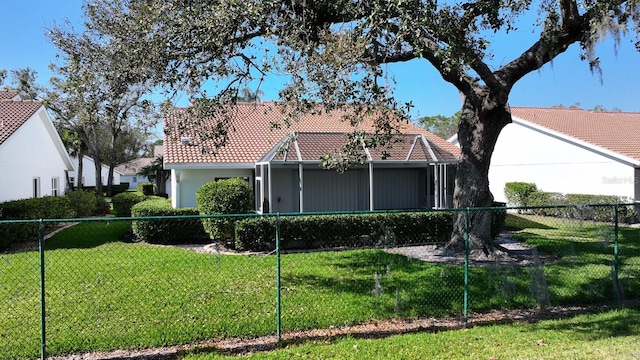 view of front of property with a tiled roof, a front lawn, and stucco siding