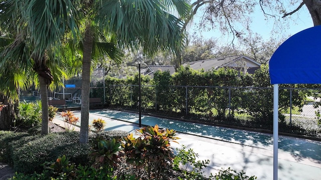 view of basketball court with fence