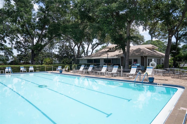 community pool featuring a patio and fence