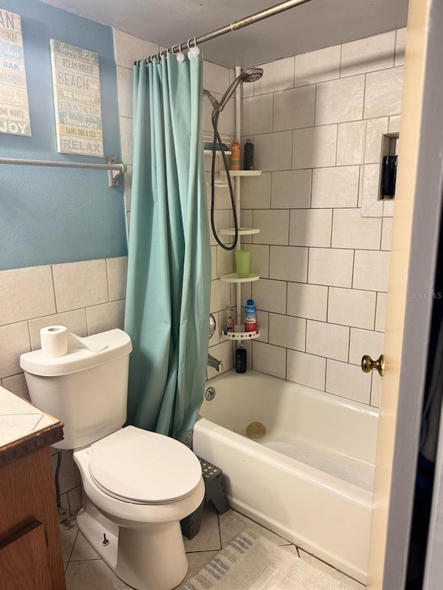 bathroom featuring toilet, tile patterned flooring, tile walls, and vanity