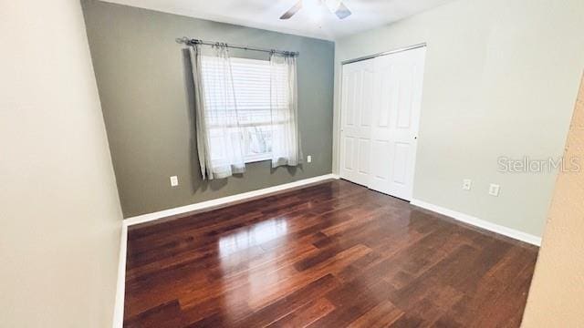 unfurnished room with ceiling fan, baseboards, and wood finished floors