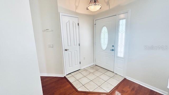 entryway featuring light wood-type flooring and baseboards