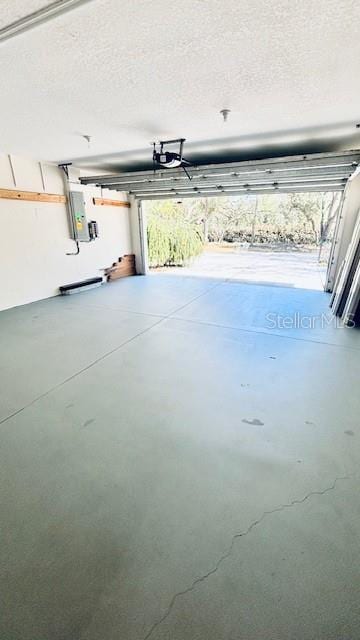 garage with electric panel and a garage door opener