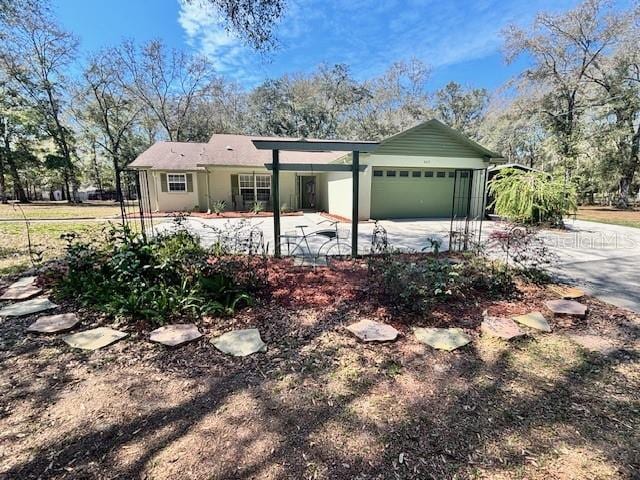 ranch-style home featuring concrete driveway and an attached garage