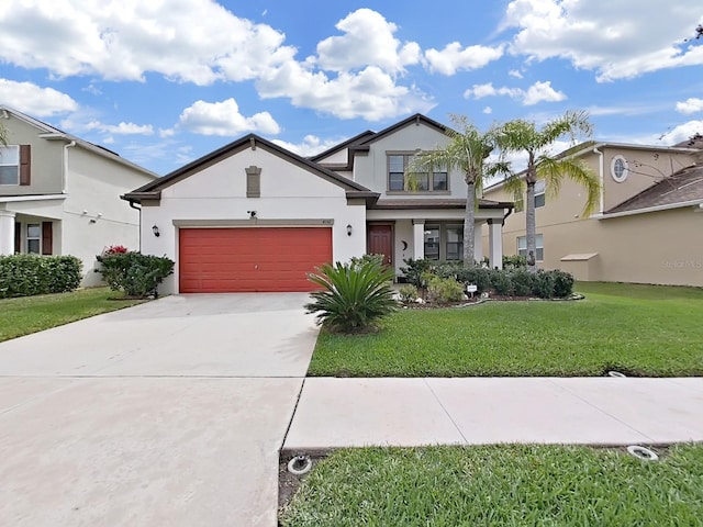 view of front facade with a garage, concrete driveway, a front lawn, and stucco siding