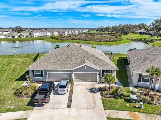 drone / aerial view featuring a residential view and a water view