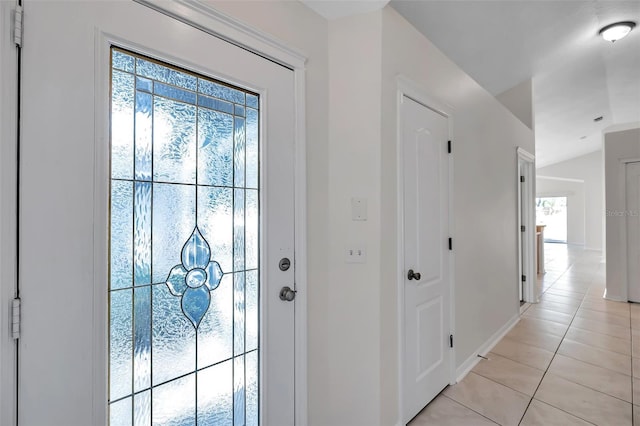 interior space with baseboards and light tile patterned floors