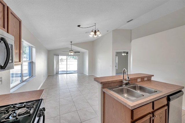 kitchen featuring visible vents, open floor plan, a kitchen island with sink, stainless steel appliances, and a sink