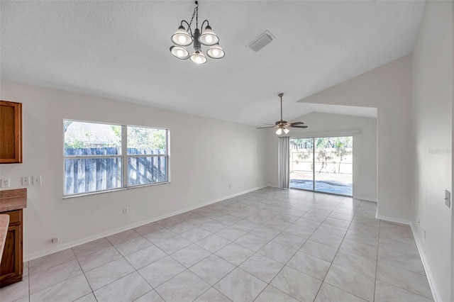 empty room featuring baseboards, visible vents, vaulted ceiling, and ceiling fan with notable chandelier