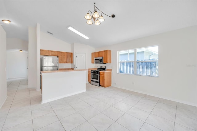 kitchen with stainless steel appliances, a center island, light countertops, and visible vents