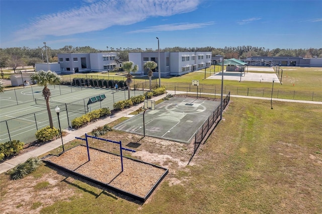 view of property's community with community basketball court, a yard, fence, and a residential view