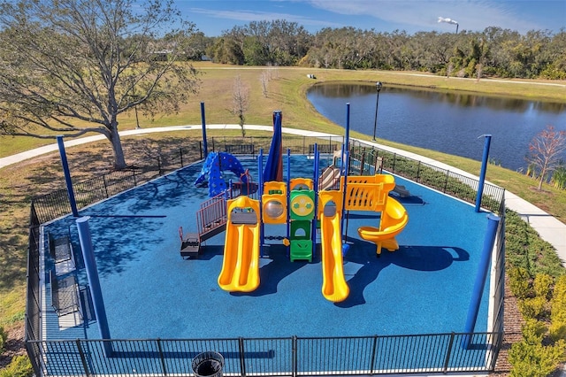 communal playground featuring a water view and fence