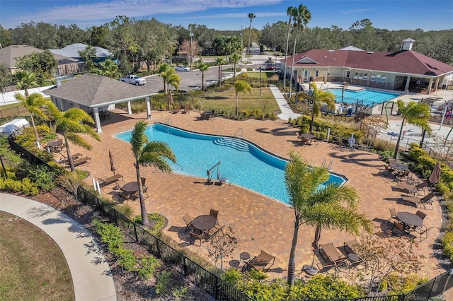 pool featuring a residential view, a patio area, and fence